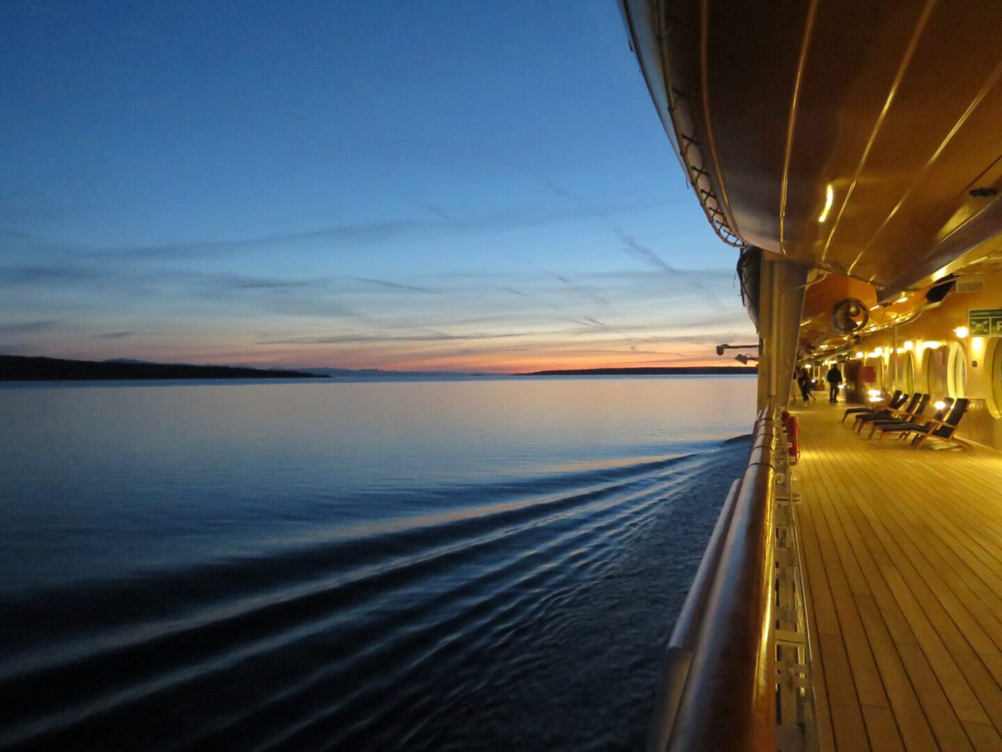 A boat is on the water at sunset.