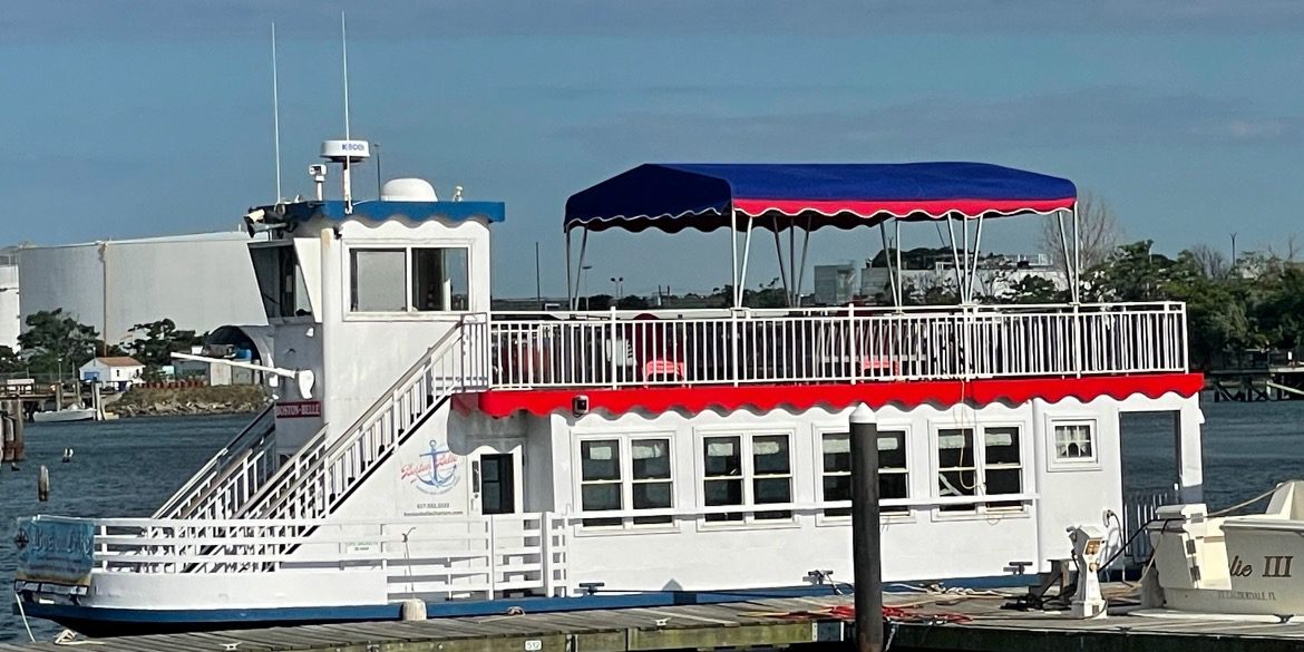 A large white boat with red and blue trim.