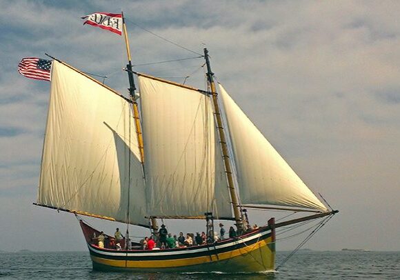 A boat with people on it in the ocean.