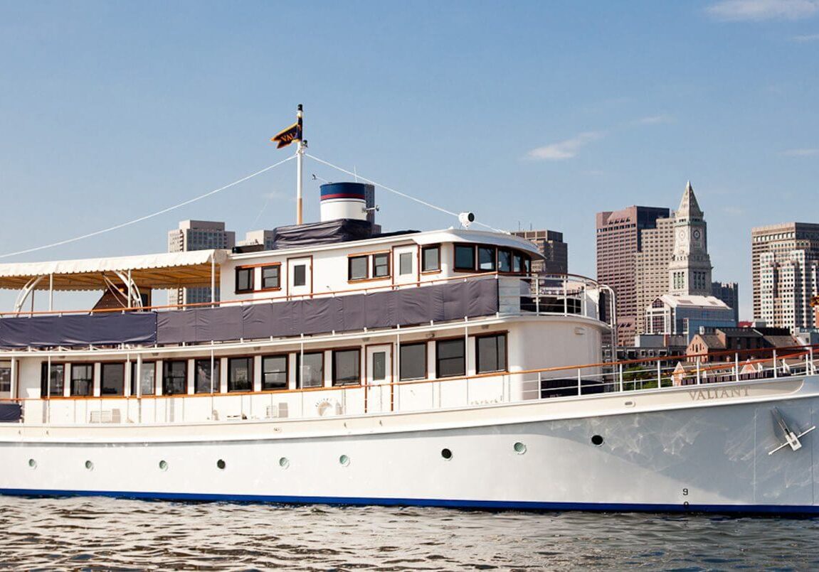 A large white boat floating on top of water.